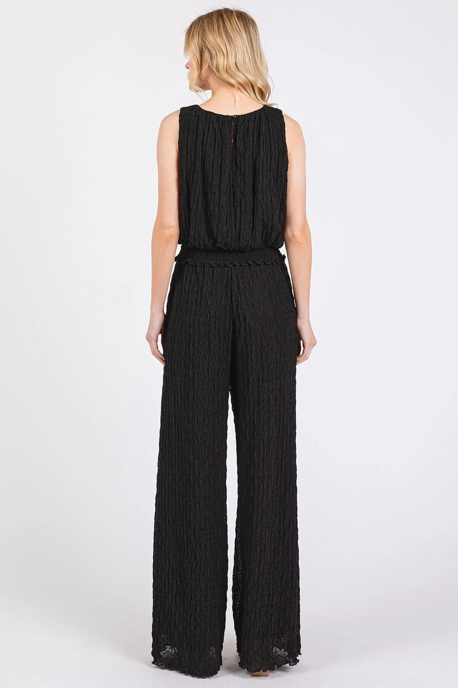 Black textured stretchy crop tank and pants set by Trendsi, featuring a fitted, comfortable design for casual wear.