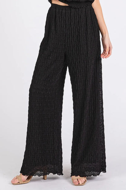 Black Mittoshop textured stretchy crop tank and pants set on a model, featuring a fitted, comfortable matching two-piece outfit.