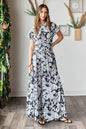 Black Mittoshop tropical print top and skirt set by Trendsi, featuring vibrant floral patterns and casual summer style.