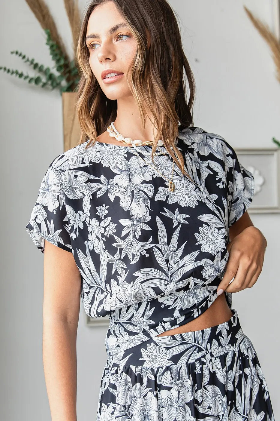 Black tropical print top and skirt set by Trendsi, featuring a stylish matching two-piece outfit with vibrant floral patterns.