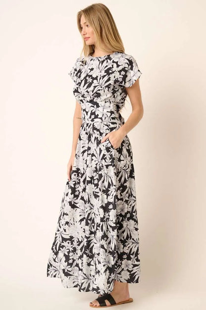Black tropical print top and skirt set by Trendsi, featuring vibrant botanical patterns, perfect for casual summer wear.