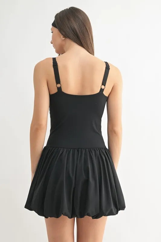 Black Mono B Bubble Active Mini Dress worn by a model, featuring a fitted silhouette and stylish design for active or casual wear.