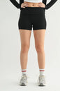 Black ribbed foldover waist shorts by Trendsi, featuring a comfortable high-rise fit and textured fabric, shown on a model.