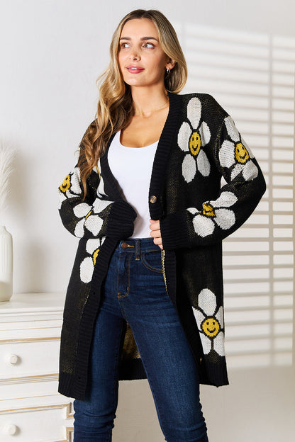 Black Perfee floral button-down longline cardigan by Trendsi, featuring a relaxed fit and decorative floral pattern.