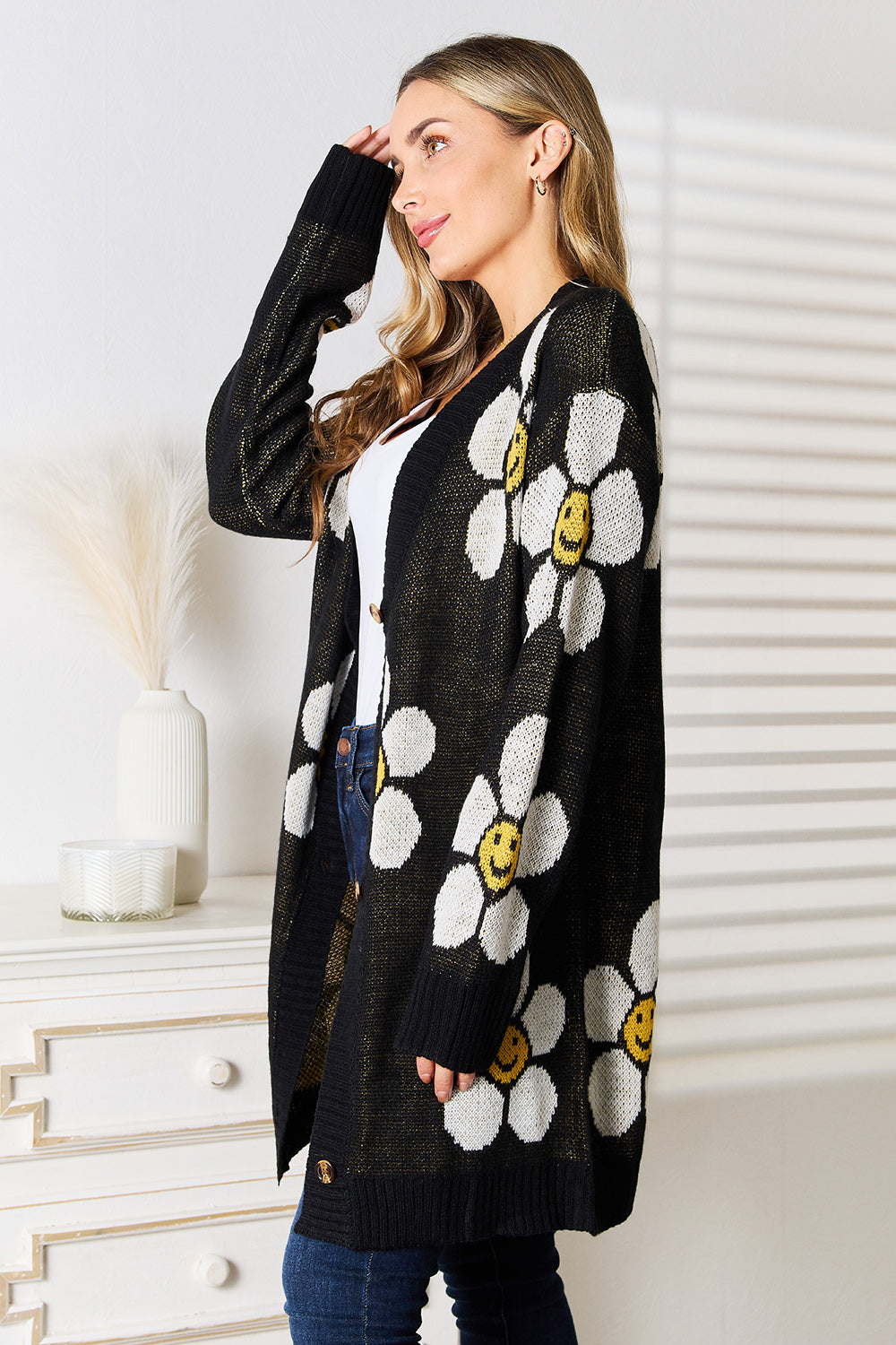 Black Perfee floral button-down longline cardigan by Trendsi, featuring a relaxed fit with floral pattern and front buttons.