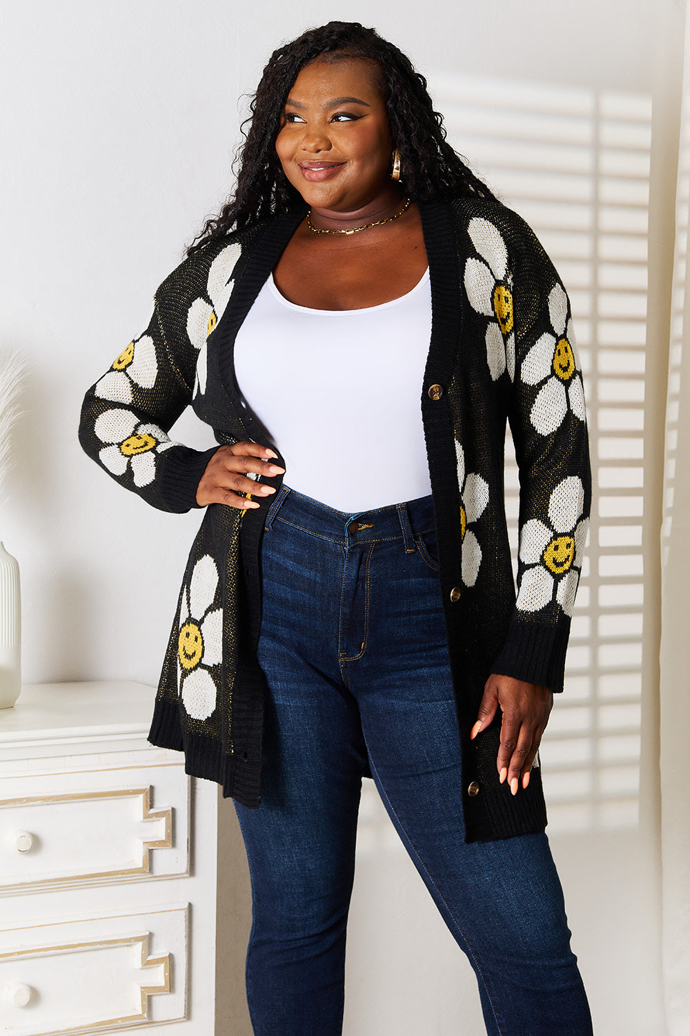 Black Perfee floral button-down longline cardigan by Trendsi, featuring a relaxed fit and floral pattern, styled with long sleeves.