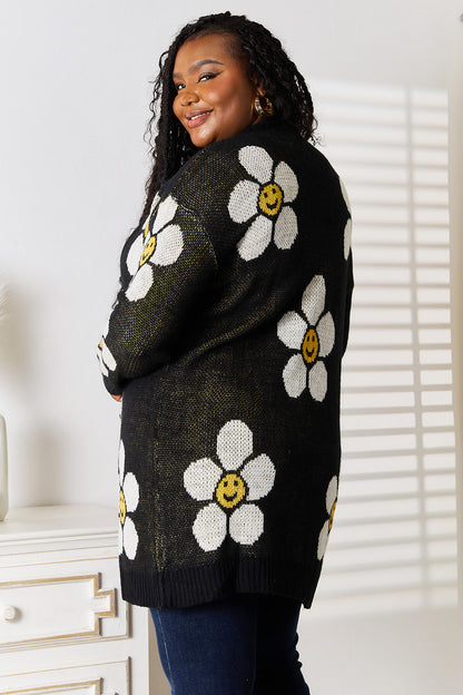 Black Perfee floral button-down longline cardigan by Trendsi, featuring a relaxed fit with floral pattern and button closure.