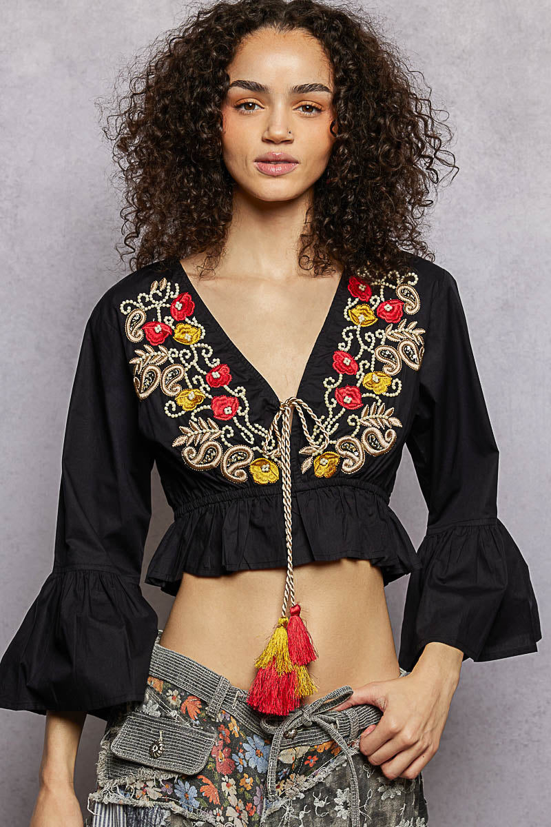 Black floral embroidered cropped blouse from Trendsi, featuring detailed embroidery and a stylish, feminine design.