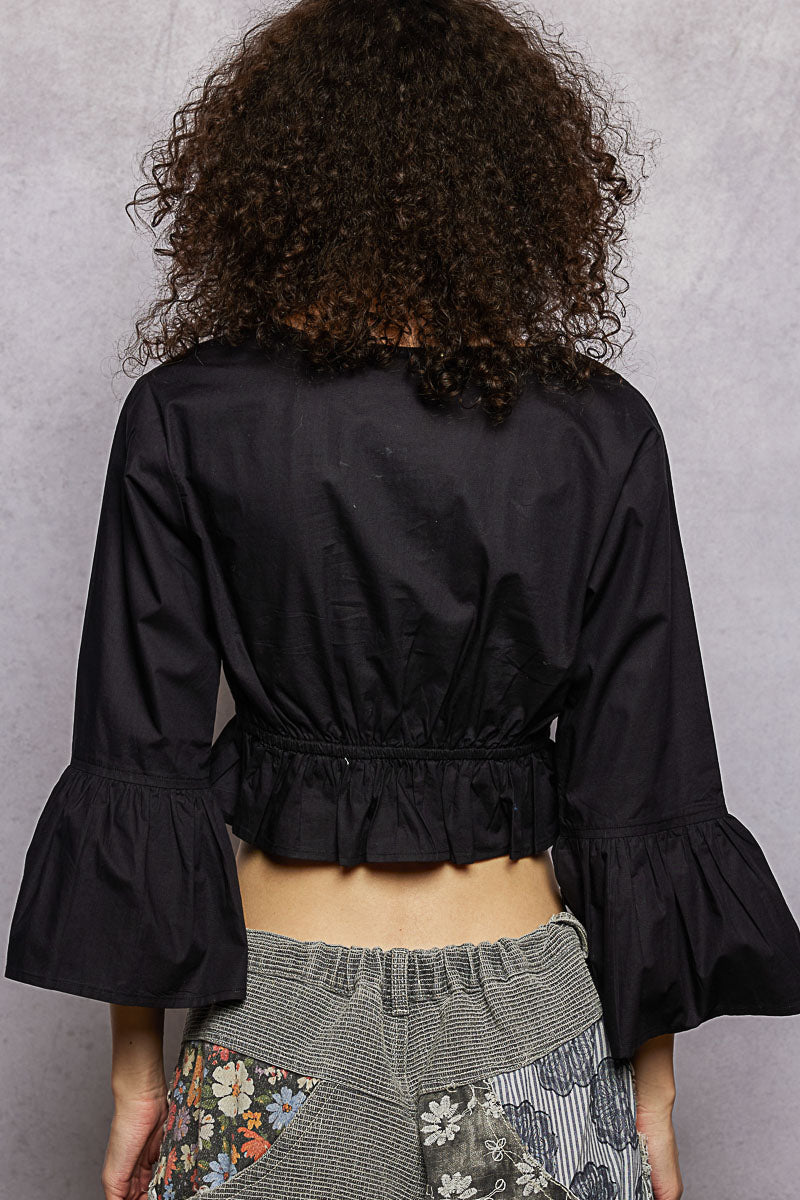 Black POL floral embroidered cropped blouse by Trendsi, featuring intricate embroidery and a stylish, fitted design.