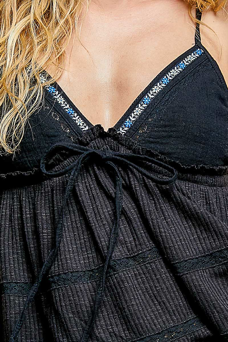 Black V-neck embroidered trim ruffled camisole by Trendsi, featuring delicate embroidery and feminine ruffle details.