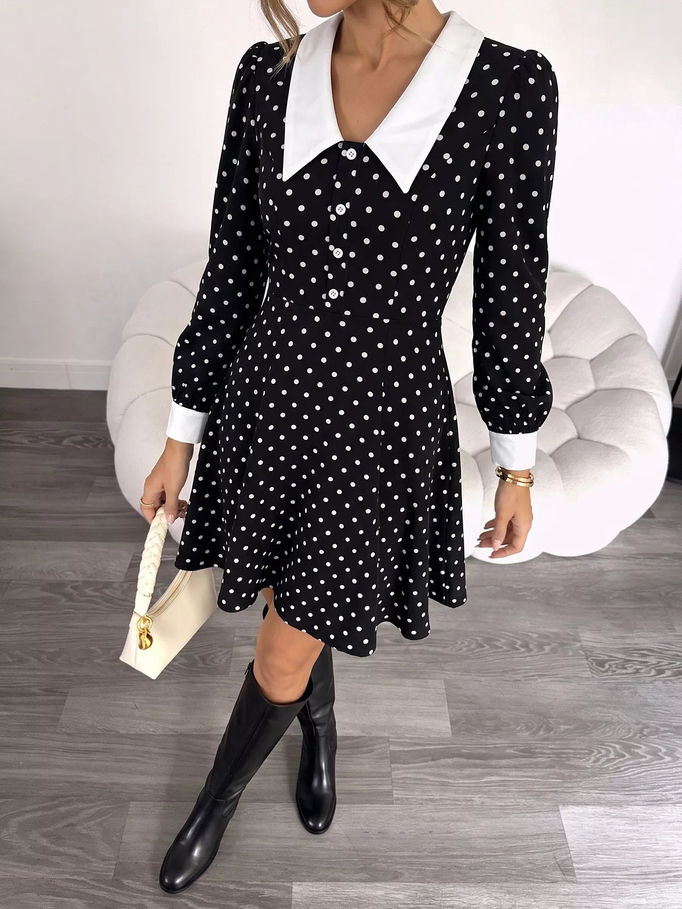 Black polka dot Peter Pan collar dress by Trendsi featuring a classic fit and elegant design, perfect for casual or semi-formal occasions.