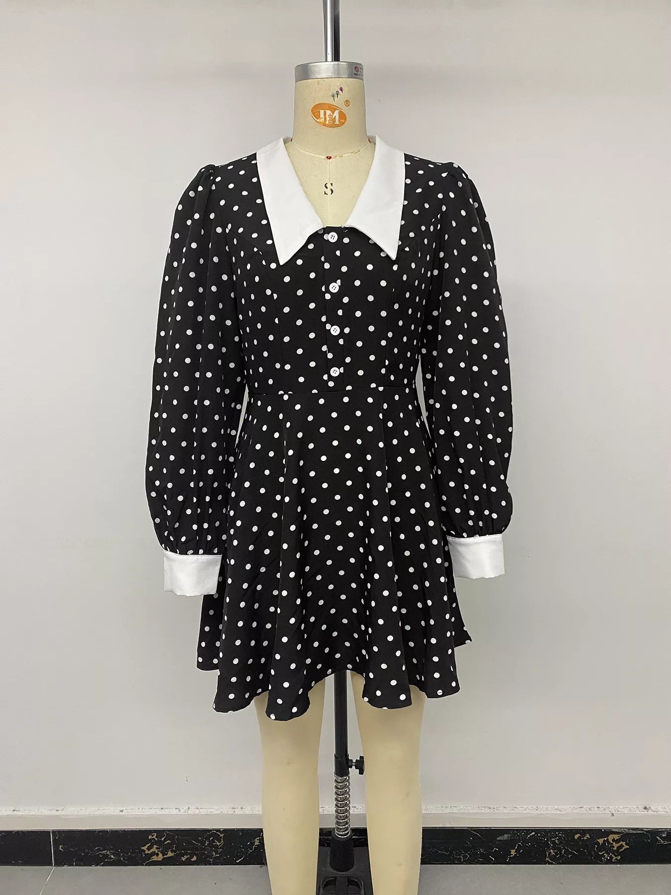 Black polka dot Peter Pan collar dress by Trendsi featuring a cute, classic design with short sleeves and a fitted waist.