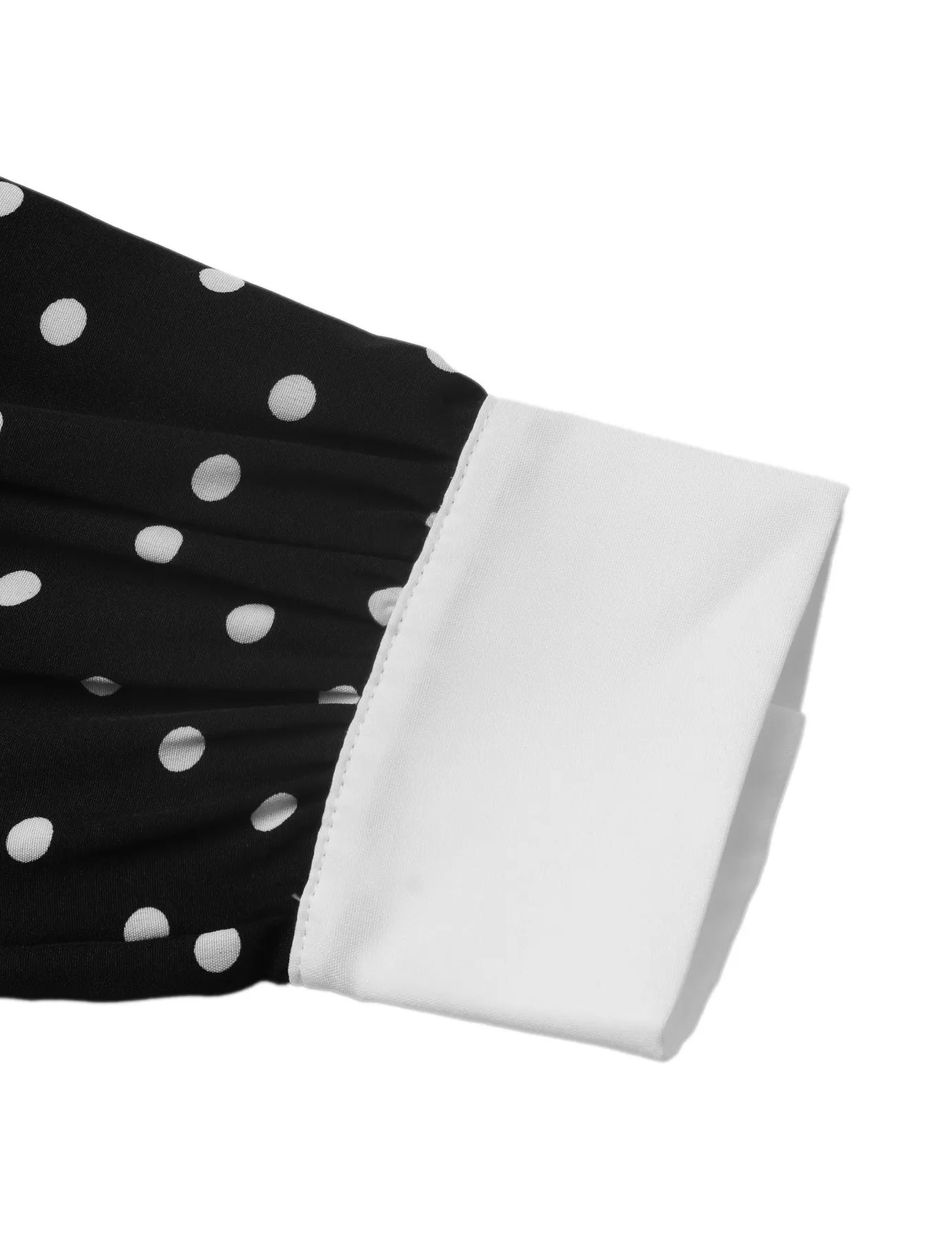 Black polka dot Peter Pan collar dress by Trendsi, featuring a classic design with a round collar and playful dot pattern.