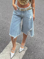 Black raw hem distressed denim shorts by Trendsi, shown with frayed edges and a casual fit on a model.