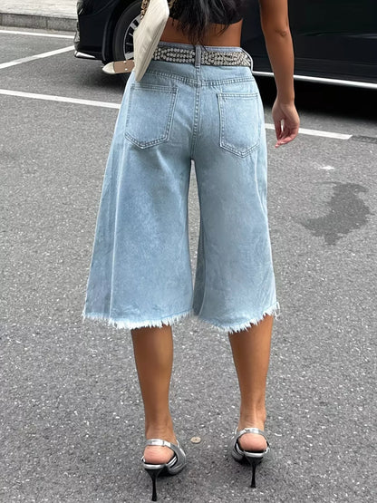 Black raw hem distressed denim shorts by Trendsi featuring frayed edges and worn-in style, perfect for casual summer outfits.