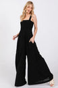Black Sage+Fig smocked flowy wide-leg jumpsuit with relaxed fit and adjustable straps, perfect for casual and stylish looks.