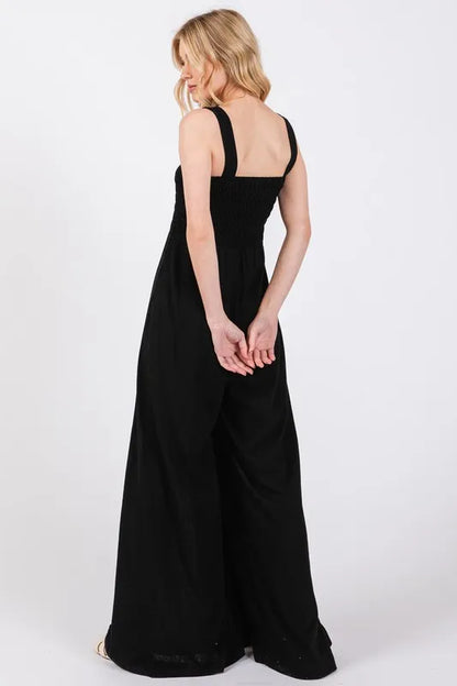 Black Sage+Fig smocked flowy wide-leg jumpsuit from Trendsi, featuring a relaxed fit, comfortable fabric, and stylish design.