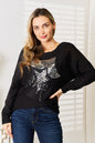 Black sequin graphic dolman sleeve knit top by Trendsi featuring glittery sequin design and relaxed fit.