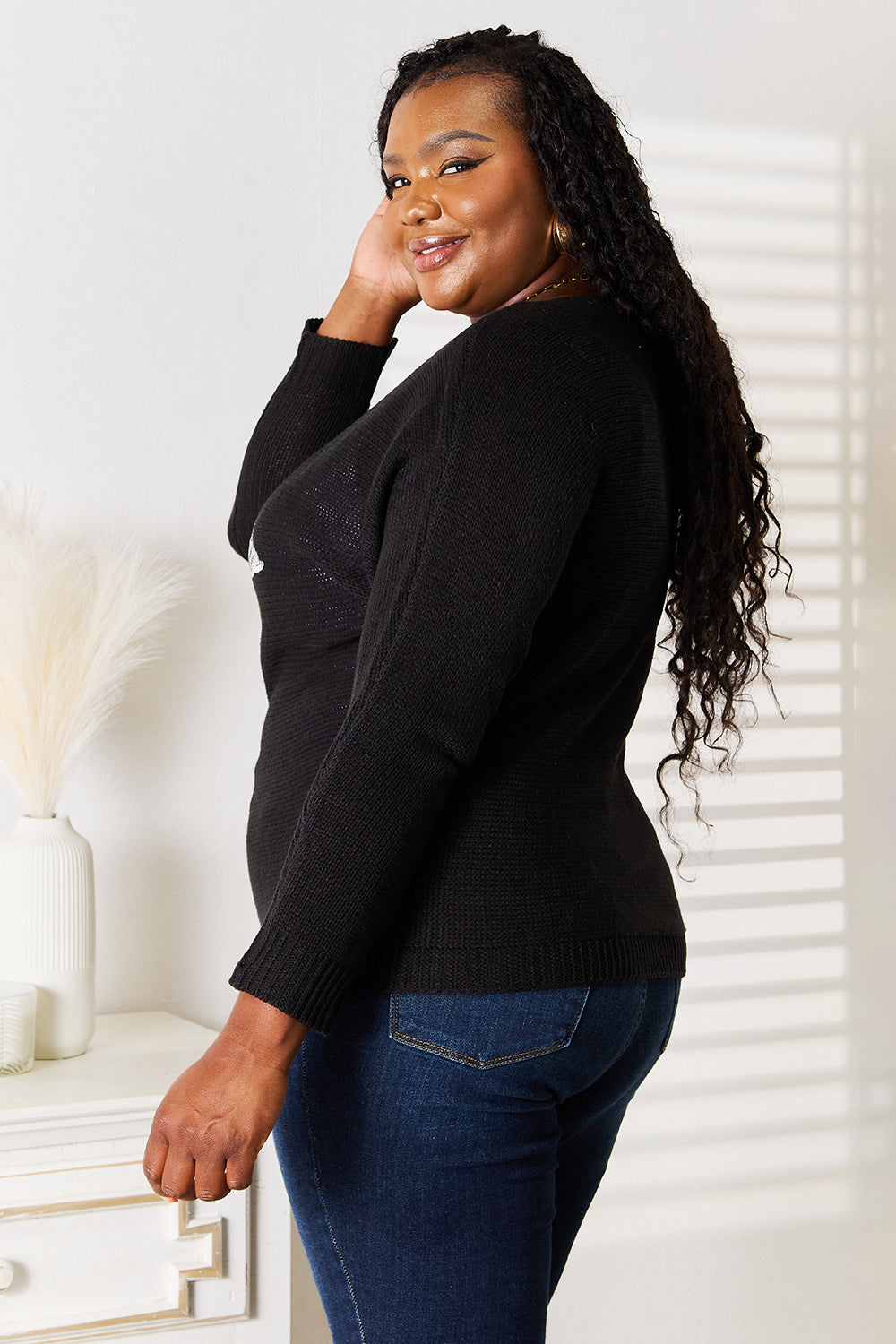 Black sequin graphic dolman sleeve knit top by Trendsi, featuring a relaxed fit, shimmering sequins, and stylish design.