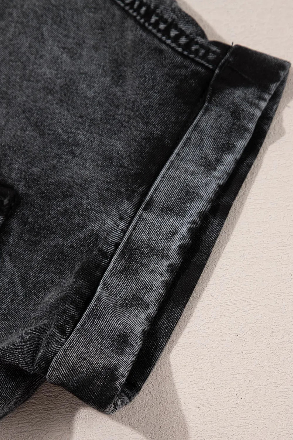 Black short sleeve denim shirt with flap pockets, button-up front, and raw hem from Trendsi.