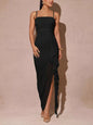Black slit asymmetrical hem spaghetti strap maxi dress by Trendsi, featuring a flowing silhouette and stylish design.