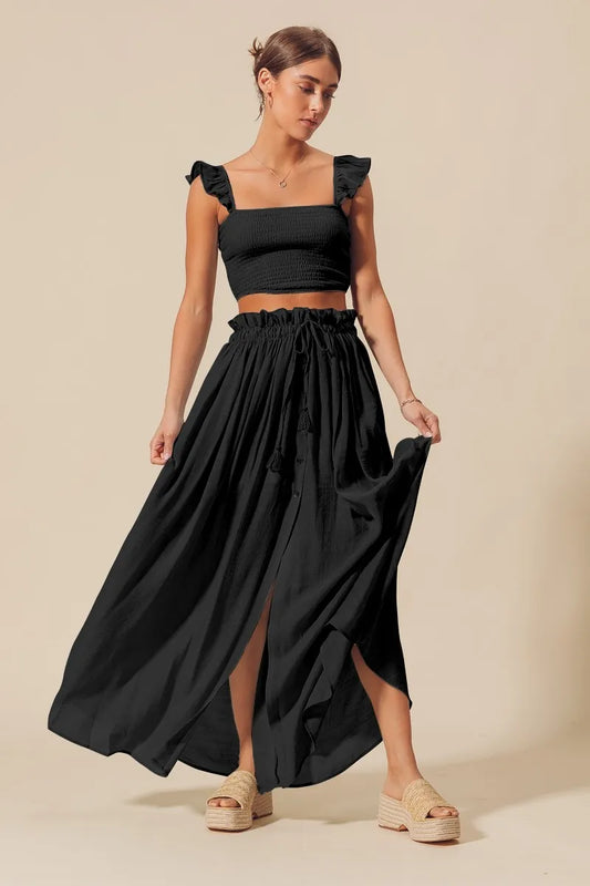 Black SO ME smocked top and flowy maxi skirt set by Trendsi, featuring a stylish, comfortable coordinated outfit.
