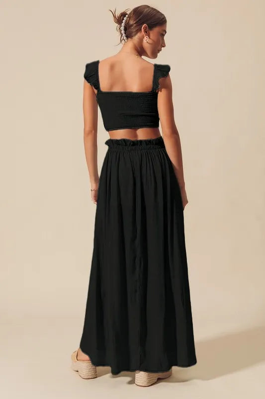 Black SO ME smocked top and flowy maxi skirt set by Trendsi, featuring a stylish, comfortable coordinated outfit.