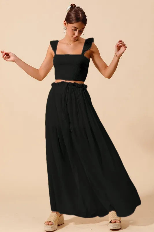 Black SO ME smocked top and flowy maxi skirt set by Trendsi, featuring a stylish and comfortable coordinated outfit.