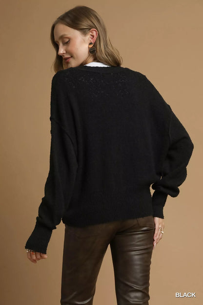 Black Umgee button-front V-neck knit cardigan with long sleeves and ribbed hem, styled on a hanger.