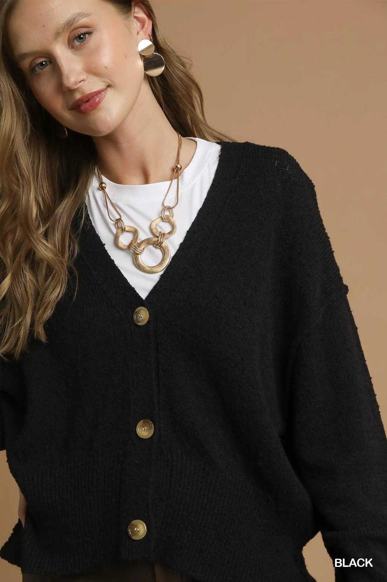 Black Umgee button-front V-neck knit cardigan featuring long sleeves and ribbed hem, styled on a model.