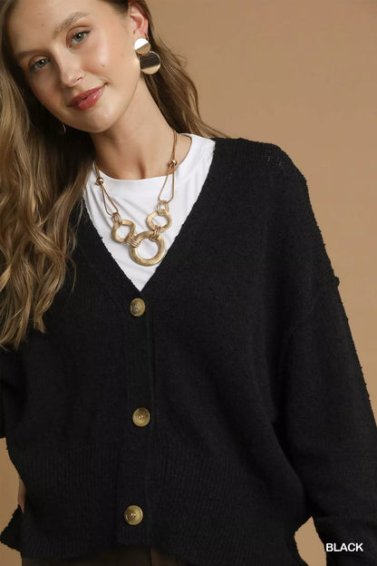 Black Umgee button-front V-neck knit cardigan featuring long sleeves and ribbed hem, styled on a model.