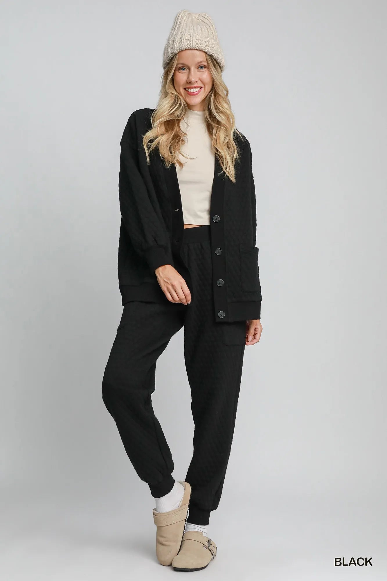 Black Umgee button-up jacquard cardigan with intricate knit pattern, styled open with long sleeves and a relaxed fit.