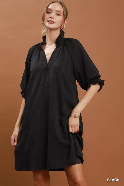 Black Umgee floral textured jacquard V-neck dress with a fitted silhouette, featuring intricate floral pattern and stylish design.