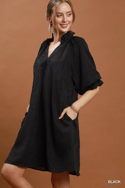 Black Umgee floral textured jacquard V-neck dress with a relaxed fit, featuring intricate floral patterns and a stylish V-neckline.