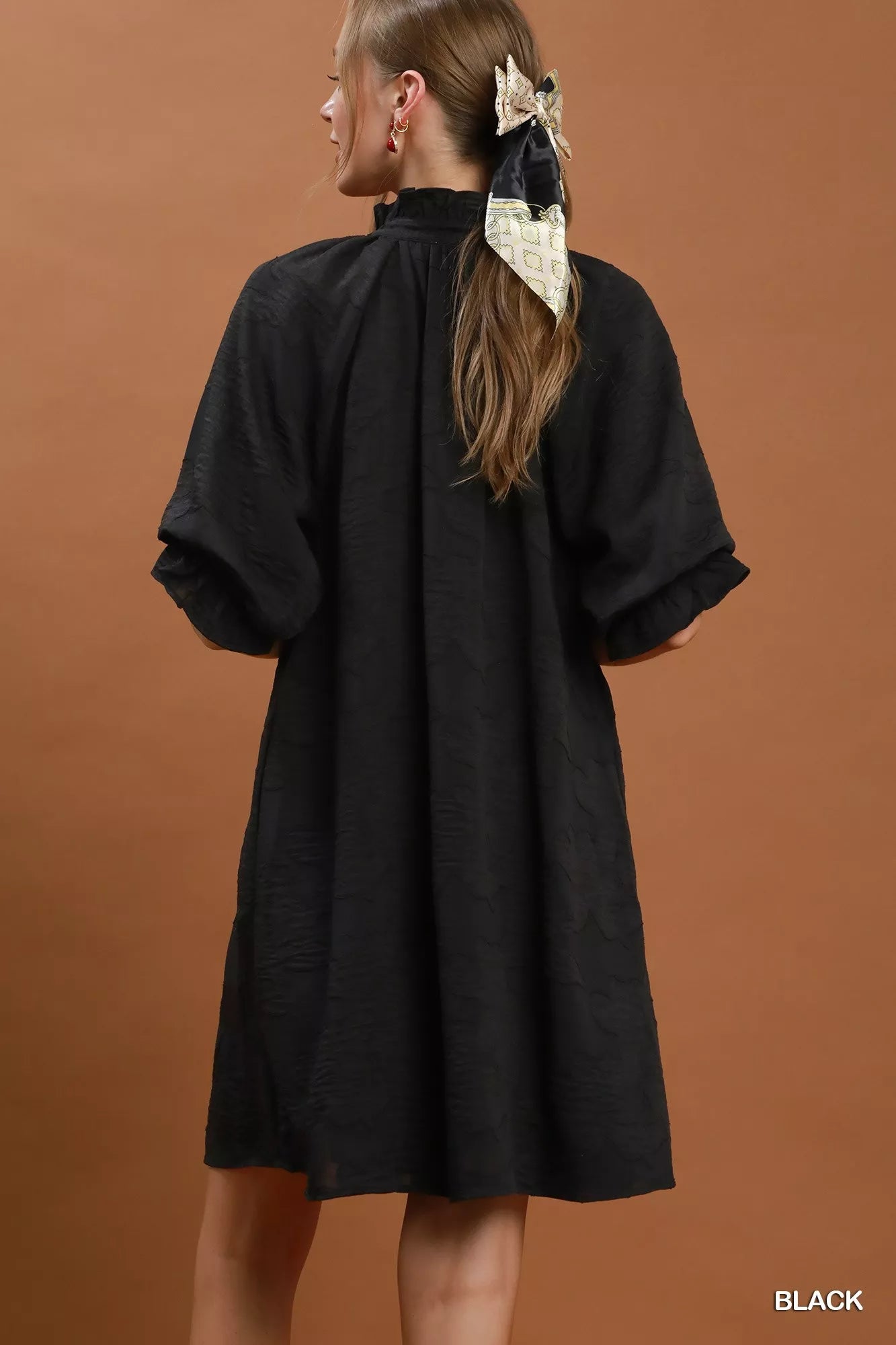 Black Umgee floral textured jacquard V-neck dress featuring a stylish design and intricate fabric pattern.