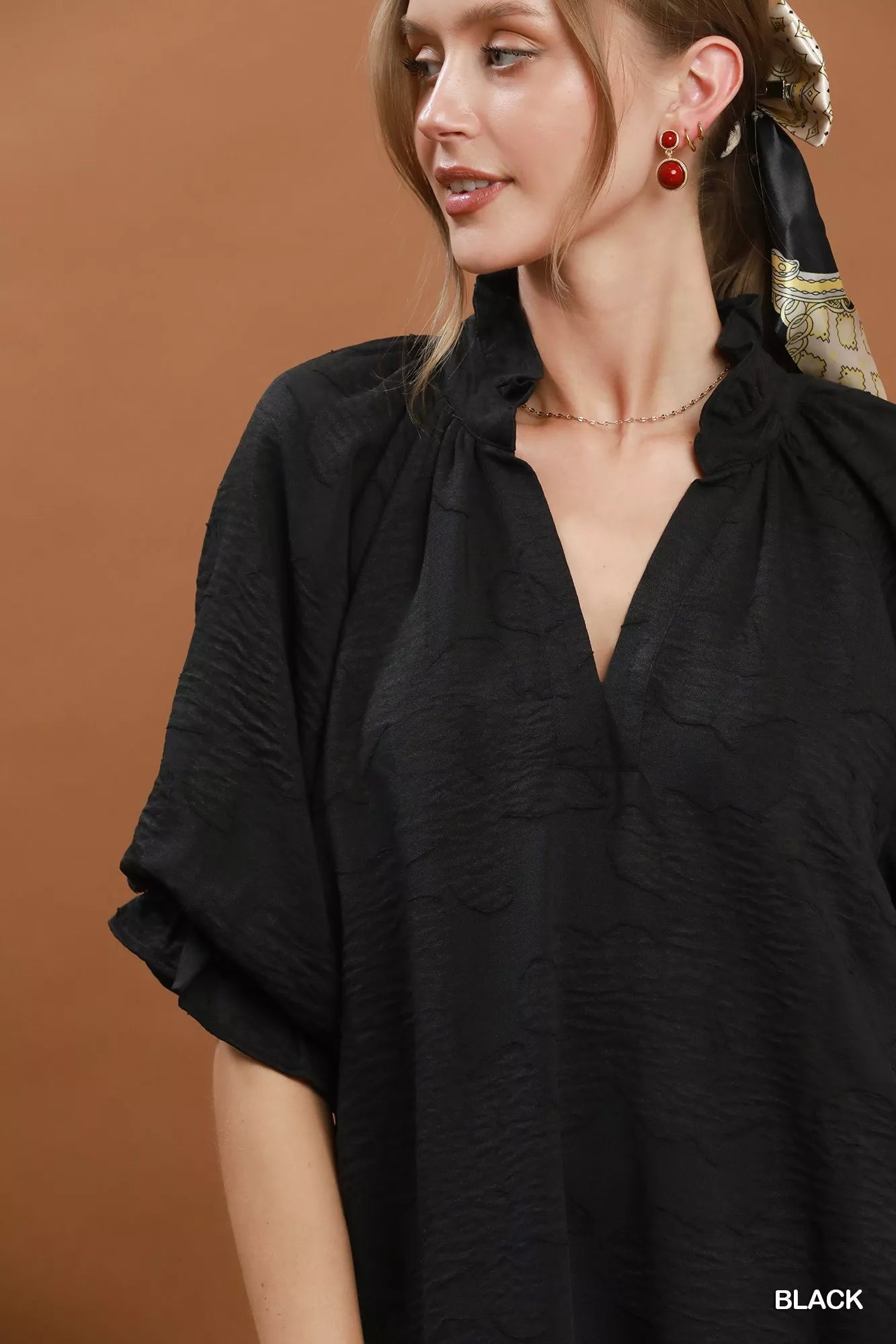 Black Umgee floral textured jacquard V-neck dress with long sleeves, featuring a stylish and intricate floral pattern.