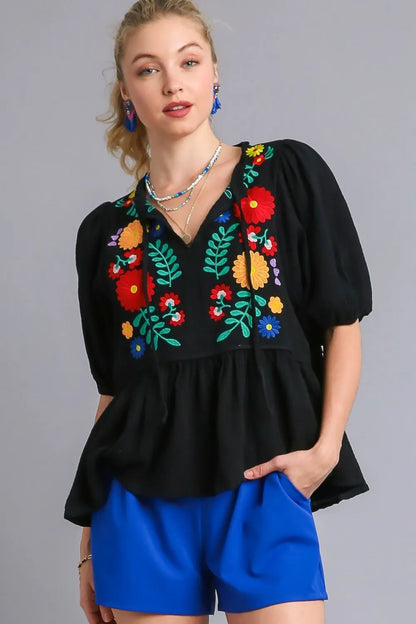 Black Umgee plus size cotton gauze babydoll blouse with floral embroidery, featuring a relaxed fit and feminine design.