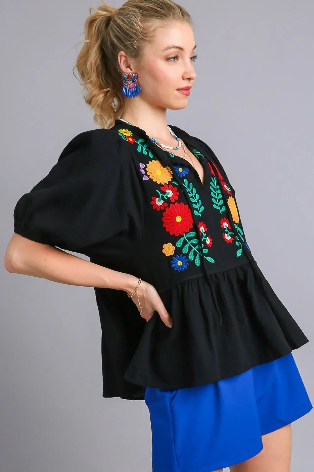 Black Umgee plus size babydoll blouse with cotton gauze fabric and floral embroidery, featuring a relaxed fit and feminine design.