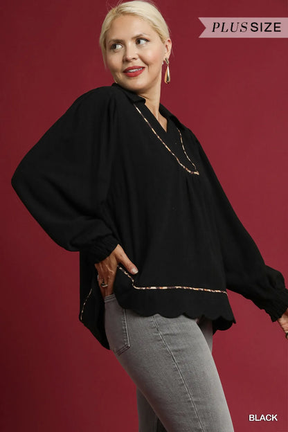 Plus size black linen blouse by Umgee featuring scallop hem and contrast trim, styled with long sleeves and relaxed fit.