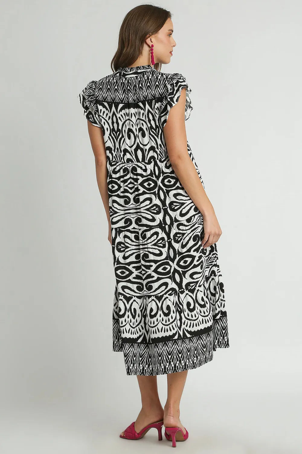 Plus size black midi dress by Umgee with two-tone border print, ruffle cap sleeves, and a flowy silhouette.