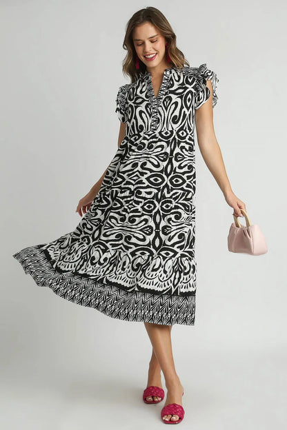 Plus size Umgee midi dress with two-tone border print, ruffle cap sleeves, in black, showcasing a stylish, flowy design.
