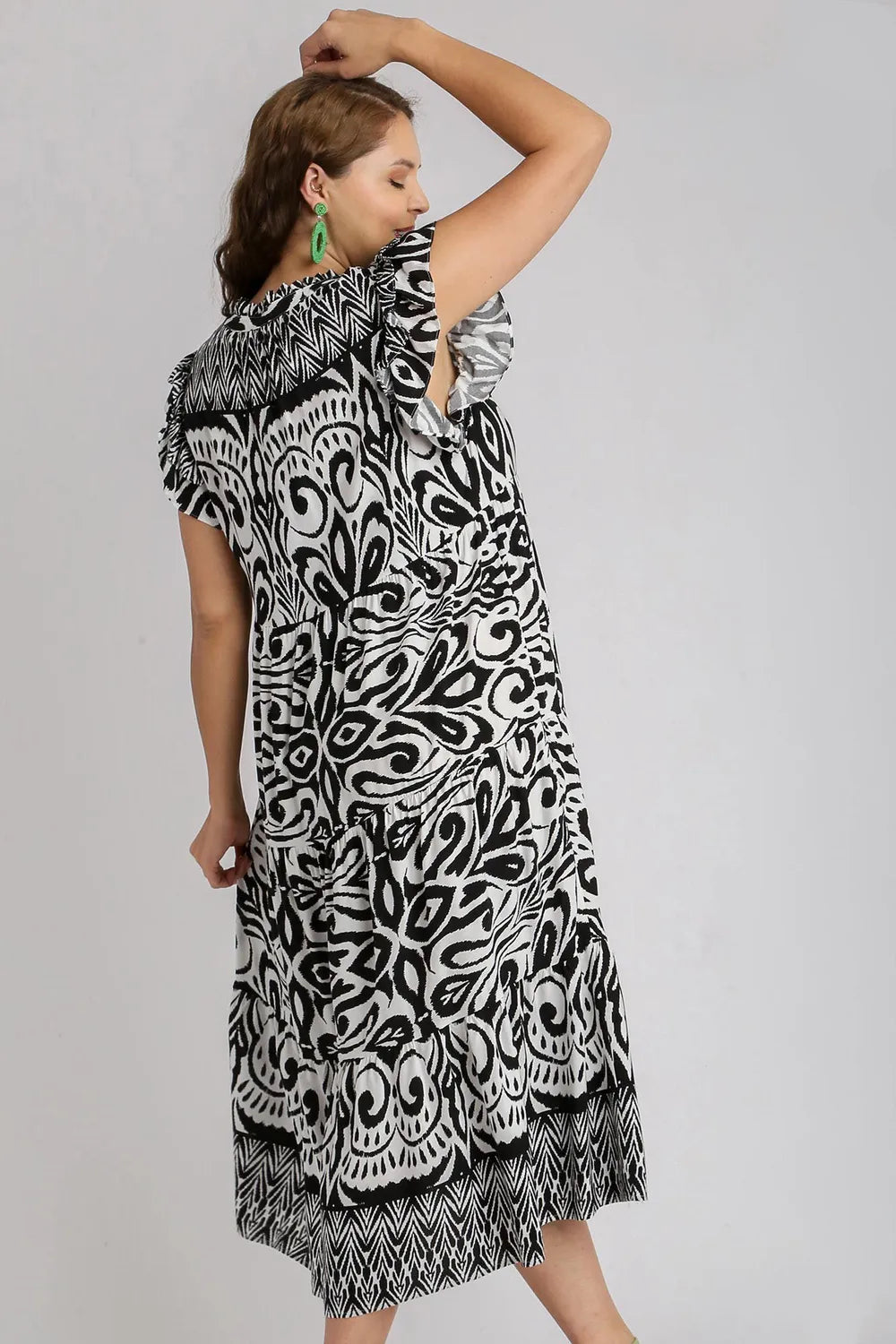 Plus size Umgee midi dress with two-tone border print, ruffle cap sleeves, and a flattering fit in black.