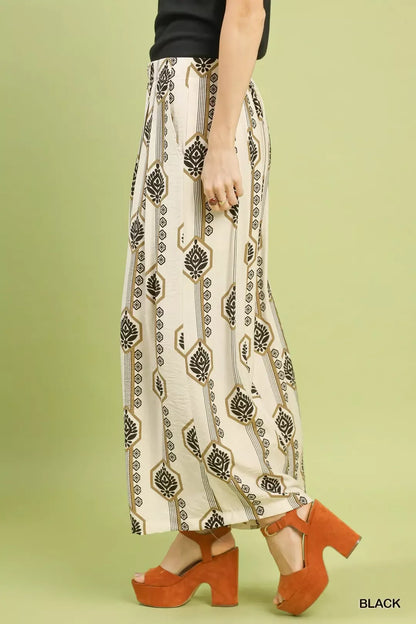 Black Umgee geometric boho print wide-leg pants with a relaxed fit, featuring bold patterns and comfortable waistband.