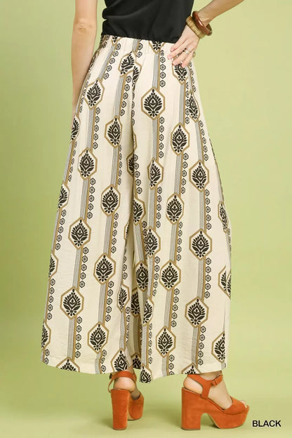 Black Umgee boho print wide-leg pants with geometric pattern, featuring a relaxed fit and flowing fabric.