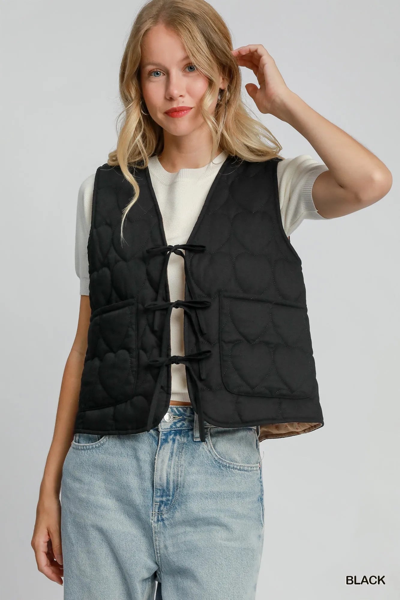 Black Umgee Heart Quilted Tie-Front Vest featuring a quilted pattern and tie closure, styled with a casual, trendy look.