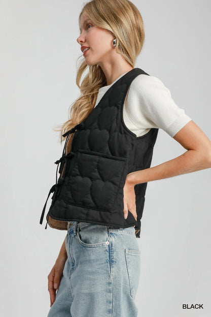 Black Umgee Heart Quilted Tie-Front Vest with front tie closure and quilted pattern, styled for a casual, layered look.