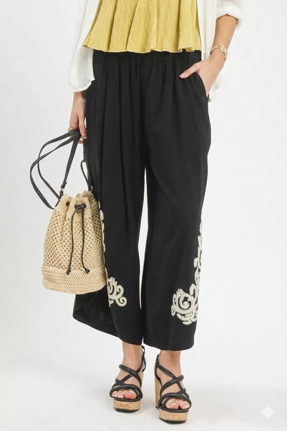 Black Umgee linen embroidered wide-leg boho pants with relaxed fit and intricate embroidery, perfect for casual or boho style.