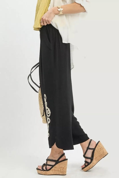 Black Umgee linen embroidered wide-leg boho pants with relaxed fit and intricate embroidery, perfect for casual and bohemian styles.