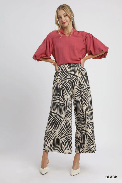Black Umgee palm leaf print wide-leg culotte pants with relaxed fit and stylish design, perfect for casual and summer outfits.