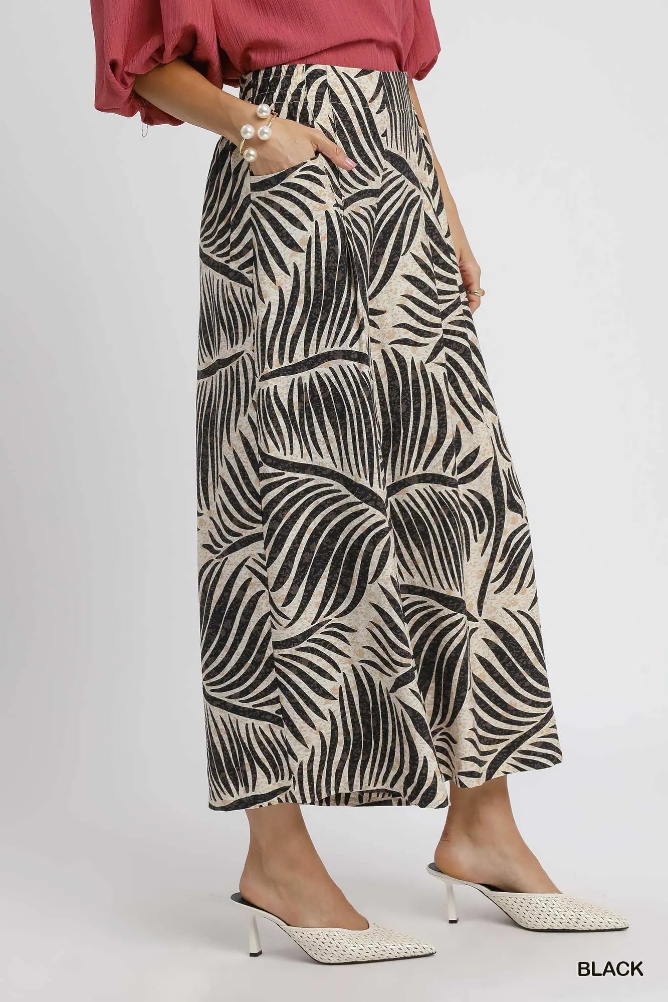 Black Umgee palm leaf print wide-leg culotte pants with relaxed fit and flowy silhouette, perfect for casual or summer wear.